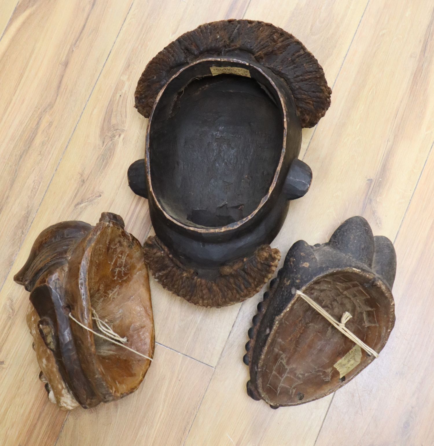 Two Lega tribal wood masks and a Bamileke wood mask (3)